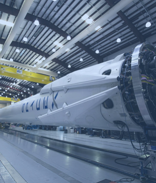 An airplane in a hangar, representing the aerospace & defense industry's need for ruggedized, mil-spec fiber assemblies from FiberElectronics.