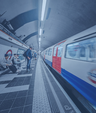 A subway train at a station platform, illustrating the transportation sector where FiberElectronics' FTTA and FTTH assemblies are deployed.